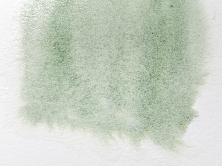 green stain of watercolor applied with the wet-on-wet technique